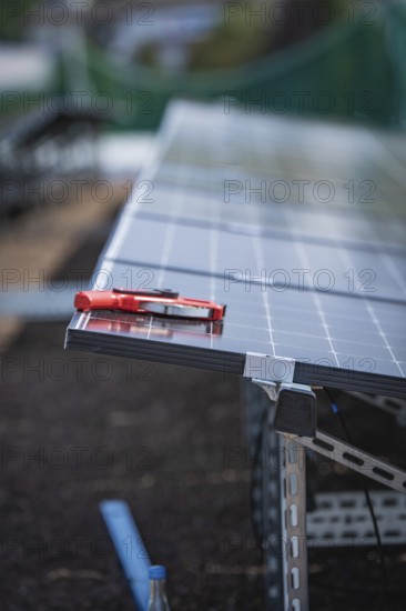 Solar modules and tools on a rack, detailed view of an installation, new Park and Ride Calw Heumaden car park on the new Hermann Hessebahn, Calw, Germany