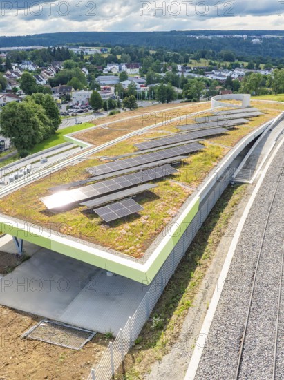 Solar system on a green roof with a view over an urban landscape, new park and ride parking garage Calw Heumaden on the new Hermann Hessebahn, Calw, Germany