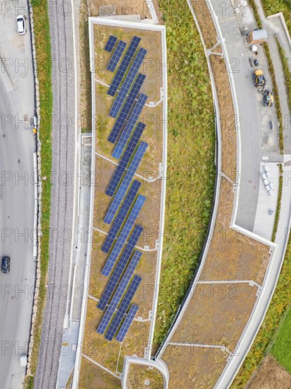 Aerial view of solar roof area in an urban area with plants and paths, new park and ride parking garage Calw Heumaden on the new Hermann Hessebahn, Calw, Germany