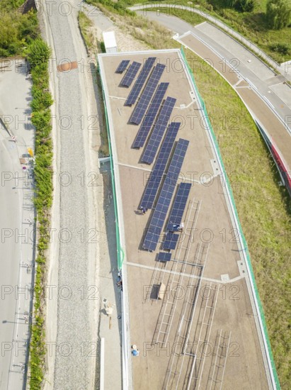 Top view of solar panel system surrounded by roads and vegetation, new park and ride car park Calw Heumaden on the new Hermann Hessebahn, Calw, Germany