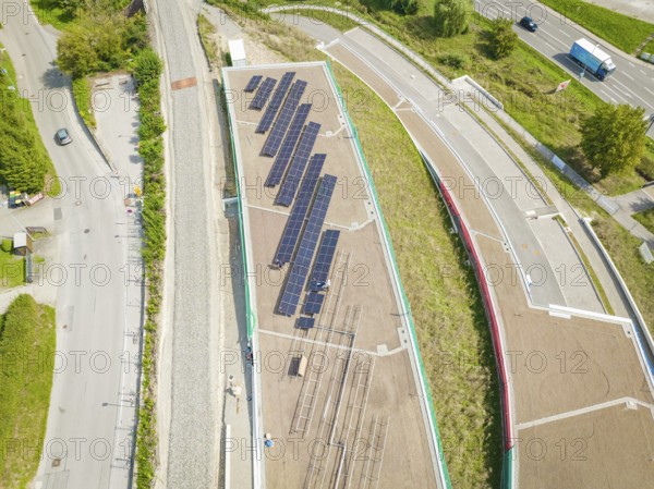 Solar system on a roof between roads and urban areas, new park and ride parking garage Calw Heumaden on the new Hermann Hessebahn, Calw, Germany