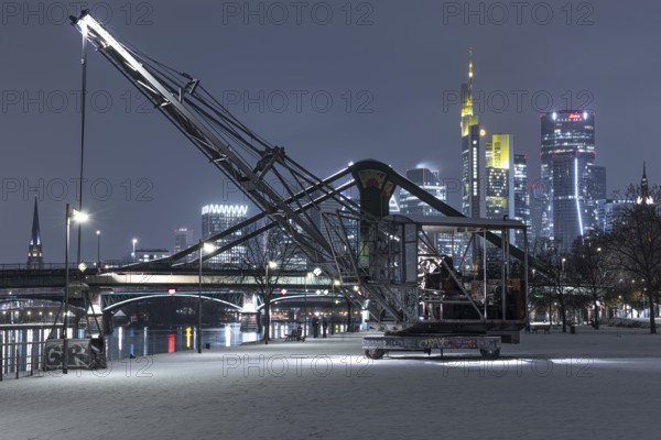 Snowfalls and freezing temperatures have transformed the banks of the Main and Frankfurt banking skyline into a white winter landscape, Frankfurt am Main, Hesse, Germany