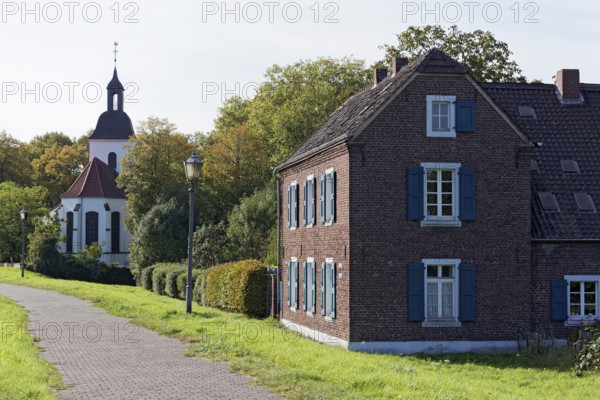 Village church and reconstructed farm from the 19th century, Nühlenhof, Rheinaue Friemersheim, Duisburg, North Rhine-Westphalia, Germany