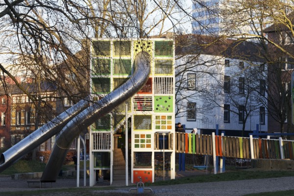 Children's playground with colorful climbing tower and slides, Immanuel-Kant-Park, Duisburg, North Rhine-Westphalia, Germany