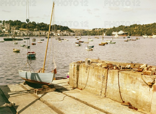 Boats at moorings in harbour of town Fowey, Cornwall, England, UK view across River Fowey estuary from Polruan, 1960s