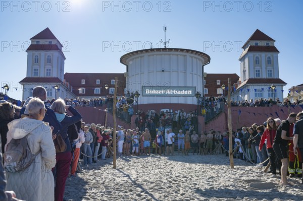 Tourists waiting in front of the spa hotel to bathe, swimmers ready to start in the water, Binz, seaside resort, Rügen island, Mecklenburg-Western Pomerania, Germany