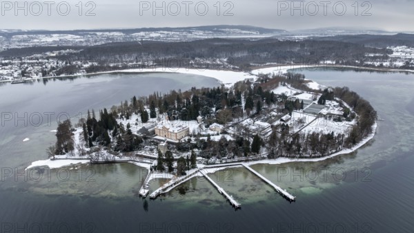The wintry and snowy Mainau island in Lake Constance with the pier and the baroque Mainau Castle, built between 1739 and 1746, aerial view, district of Constance, Baden-Württemberg, Germany