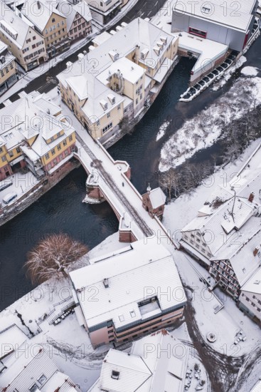 Snowy city view with a bridge across a river, Calw, Black Forest, Germany