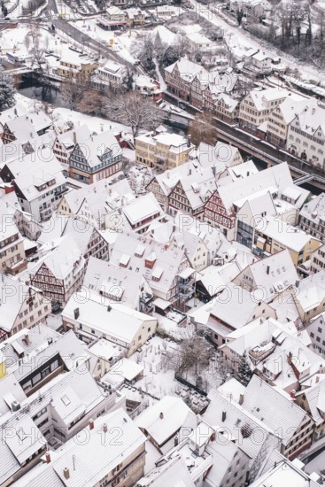 Roof view of snow-covered half-timbered houses in a historic town, Calw, Black Forest, Germany