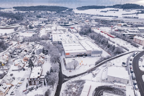 Aerial view of snowy industrial landscape with buildings and roads, Calw, Black Forest, Germany