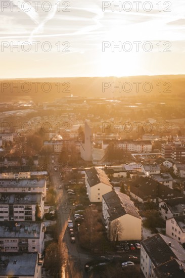 Aerial view of a city at sunset, warm colors, modern buildings and roads, Calw, Black Forest, Germany