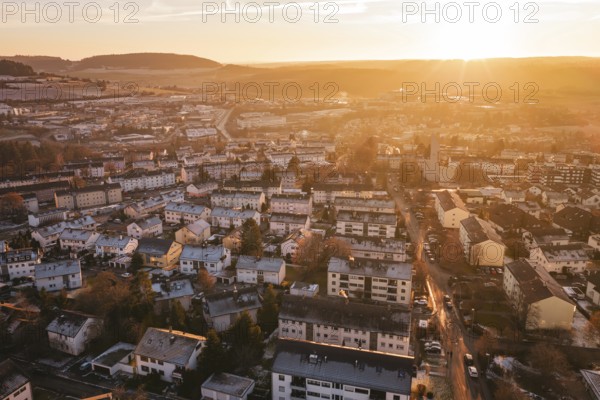 View of an urban landscape at sunset, with highly visible hills in the background, Calw, Black Forest, Germany
