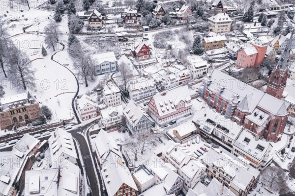 Winter village view with church and snow-covered houses, Calw, Black Forest, Germany