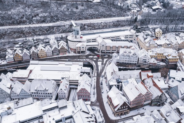 Aerial view of a snowy town with half-timbered houses and roads in winter, Calw, Black Forest, Germany
