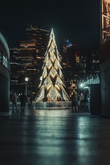 Large illuminated Christmas tree on a square in the city, London, England, Great Britain