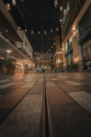 Paved street with fairy lights and urban flair in a friendly evening mood, London, England, Great Britain