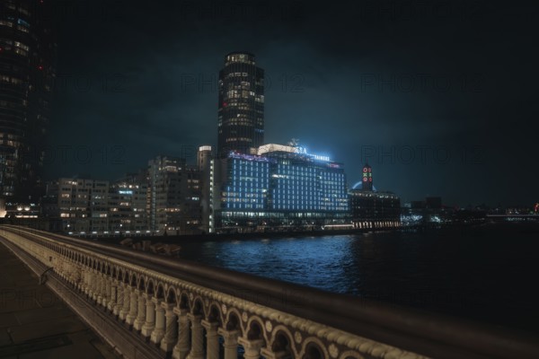 City view at night with glowing buildings and a bridge over a river, London, England, Great Britain