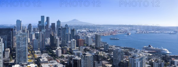 Panoramic Seattle financial district skyline in city downtown with Mount Rainier in the background