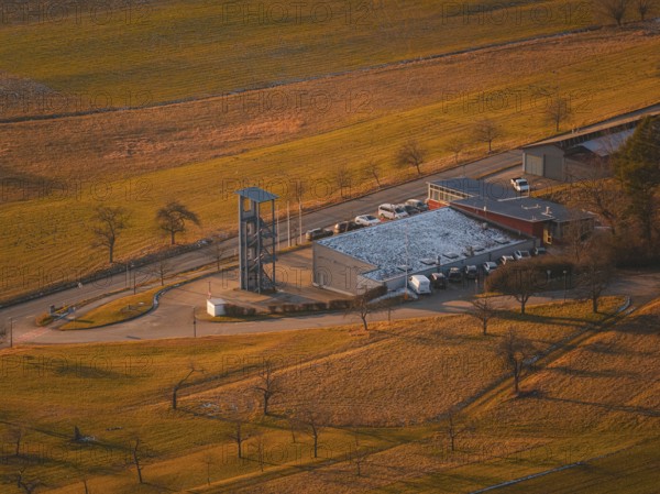 Close-up of fire station with chimney and snow-covered roof in the middle of fields, Althengstett, Calw district, Germany