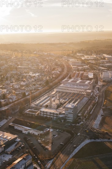 Industrial buildings and roads in a snowy urban landscape at dusk, Althengstett, Calw district, Germany