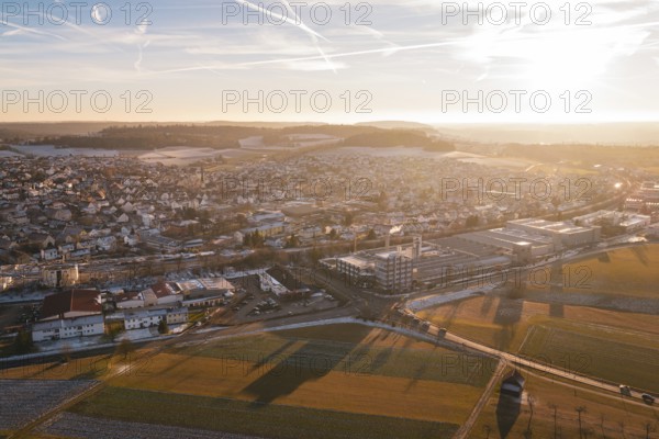 Expansive aerial view of a town in winter at sunset with fields in the foreground, Althengstett, Calw district, Germany