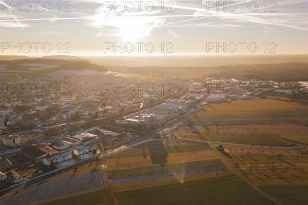 Sunset scene with a town and vast fields in the foreground, Althengstett, Calw district, Germany