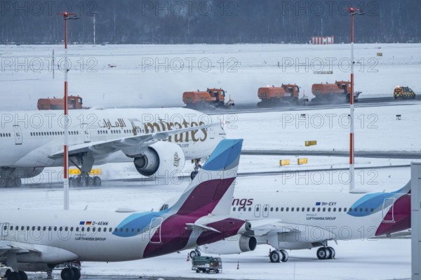 The onset of winter in North Rhine-Westphalia, flight operations are maintained at Düsseldorf airport with great effort, taxiways, runway are freed from snow and ice with many clearing vehicles, airplanes are de-iced in front of takeoff, North Rhine-Westphalia, Germany
