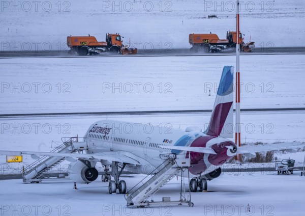 The onset of winter in North Rhine-Westphalia, flight operations are maintained at Düsseldorf airport with great effort, taxiways, runway are freed from snow and ice with many clearing vehicles, airplanes are de-iced in front of takeoff, North Rhine-Westphalia, Germany