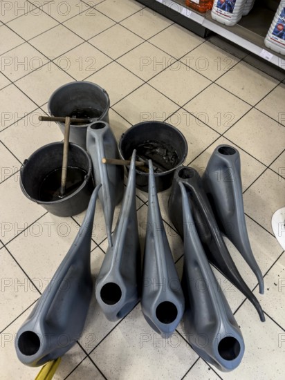 Winter, water cans and buckets with washing water for car windows, are provided in a gas station, in the interior, there are sub-zero temperatures outside