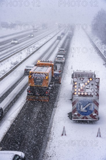 The onset of winter in North Rhine-Westphalia, heavy snowfall, A3 motorway near Hilden, near Ohligser Heide rest area, snow-covered roads, winter service of the motorway maintenance department with stray and clearing vehicles, traffic is sometimes only stalled, North Rhine-Westphalia, Germany