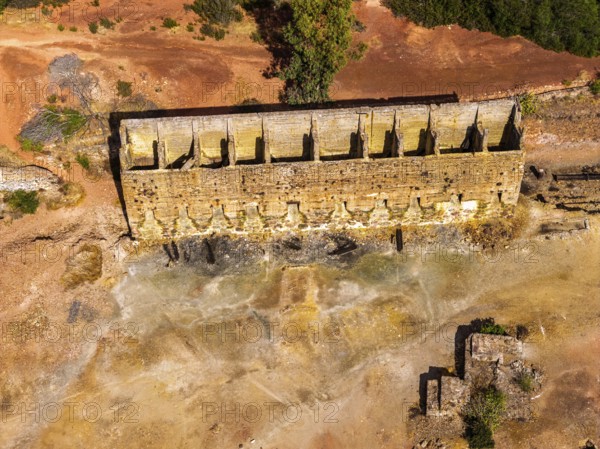 Ruins of former ore dock, Mina de Sao Domingos, historic copper open-pit mine, aerial view, Portugal