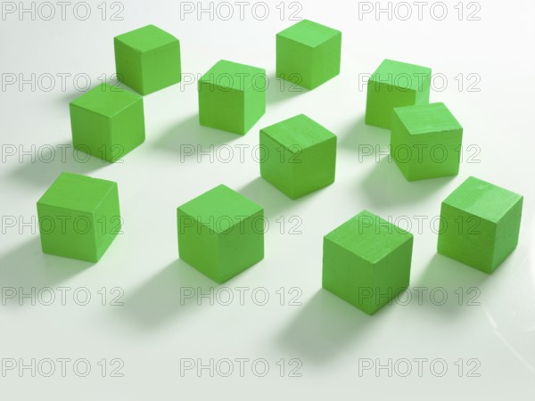 11 green wooden cubes against a white background