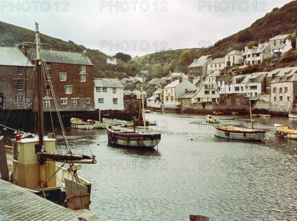 Historic waterfront buildings around the harbour river mouth of the River Pol at village of Polperro, Cornwall, England, UK