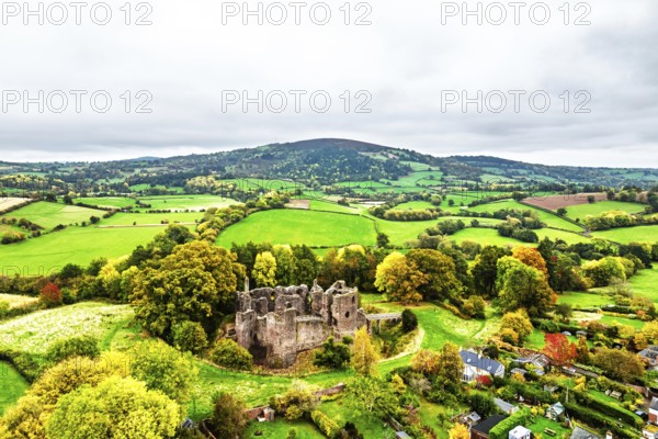 Autumn Colours over ruins of Grosmont Castle from a drone, Grosmont, Monmouthshire, Wales, UK