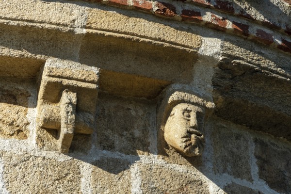 Issoire. Pillar (The Annunciation made to Mary) . The figures are illuminated by colorful light shining through a stained glass window inside Saint Austremoine Abbey, Puy de Dome, Auvergne Rhone Alpes, France