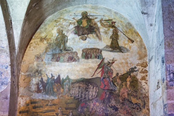 Issoire. Pillar (The Annunciation made to Mary) . The figures are illuminated by colorful light shining through a stained glass window inside Saint Austremoine Abbey, Puy de Dome, Auvergne Rhone Alpes, France
