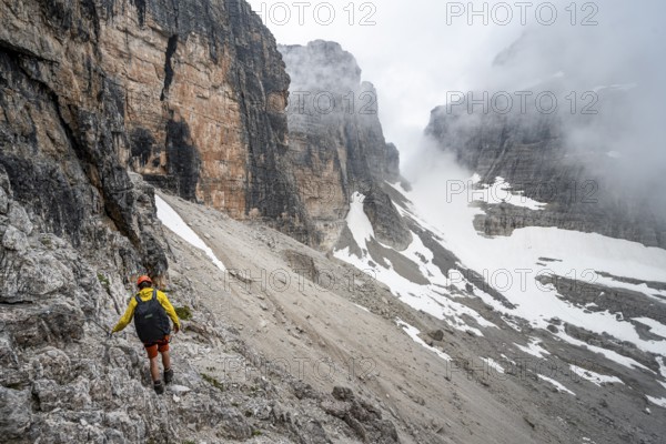 Two mountaineers descending to Rifugio Alimonta, Brenta Mountains, Trentino, Italy