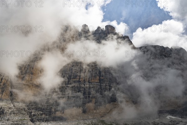 Cloudy steep rock face, Brenta Mountains, Trentino, Italy
