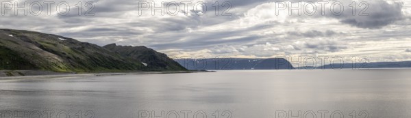 Coastal panorama with Tanafjord, mountains and dramatic sky with clouds, Store Molvik, Berlevåg, Finnmark, Norway