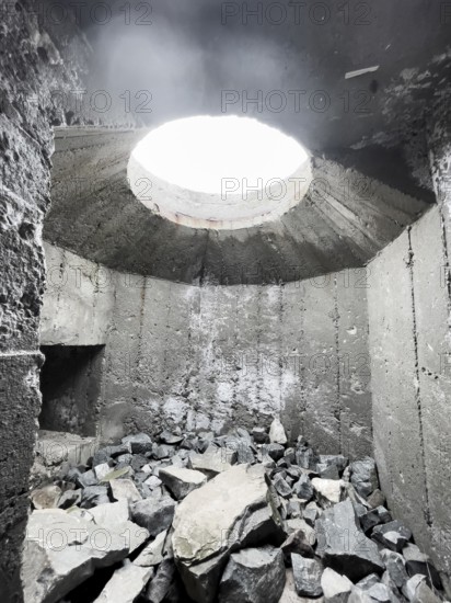 Old Wehrmacht anti-aircraft bunker from the Second World War with worn stairs in a dilapidated, dark environment, Båtsfjord, Finnmark, Norway
