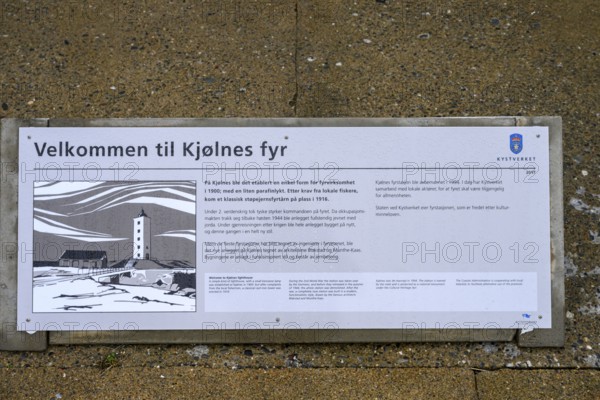 Iformative panel about Kjølnes Fyr lighthouse on a concrete floor with coastal illustration, Berlevåg, Finnmark, Norway