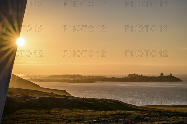 Midnight sun on Mount Domen in the background the city of Vardø, a solar star is being built on a modern building planned by Architekturbüre Biotope, Kiberg, Finnmark, Norway
