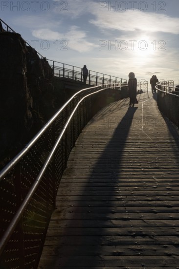 Walkers, tourists on hiking trail, Þingvellir National Park, impressive Almannagja Gorge, Allmännerschlucht, backlight, Golden Circle, Mid-Atlantic Ridge, Iceland