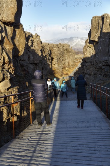 Walkers, tourists on hiking trail, Þingvellir National Park, impressive Almannagja Gorge, Allmännerschlucht, Golden Circle, Mid-Atlantic Ridge, Iceland