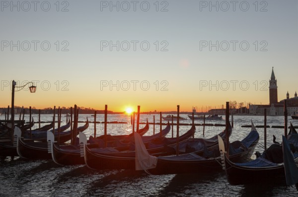 Sunrise in front of the Piazzetta with a view of the gondolas and the Isola di San Giorgio, San Marco, Venice, Veneto, Italy