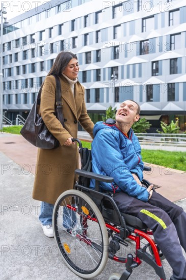 Caregiver pushing a man with a disability in a wheelchair outdoors, both smiling and sharing a happy moment during an urban outing, highlighting inclusion and support in daily life