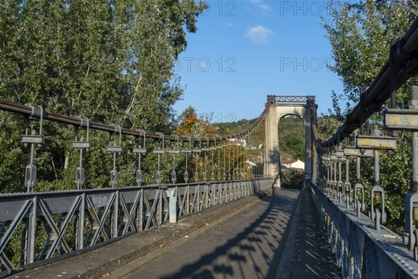 Suspension bridge of Coudes village on river Allier. Puy de Dome. Auvergne Rhone Alpes. France