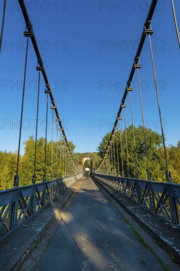 Suspension bridge of Coudes village on river Allier. Puy de Dome. Auvergne Rhone Alpes. France
