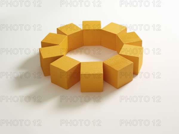 10 yellow wooden cubes against a white background