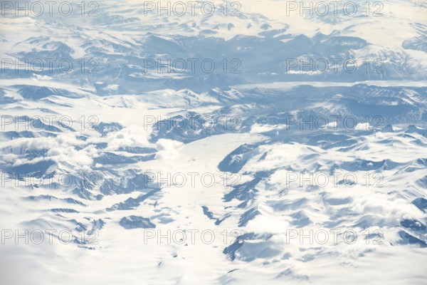 Icy, snowy arctic mountain landscape with glaciers, aerial view, Greenland, Arctic